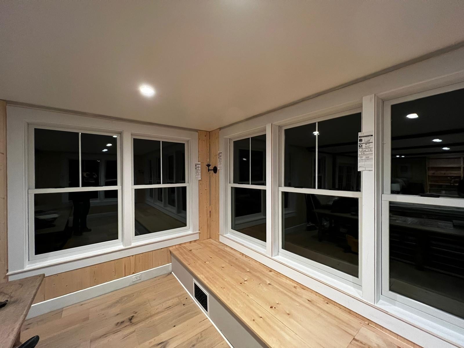 Bright sunroom with wood floor and large windows